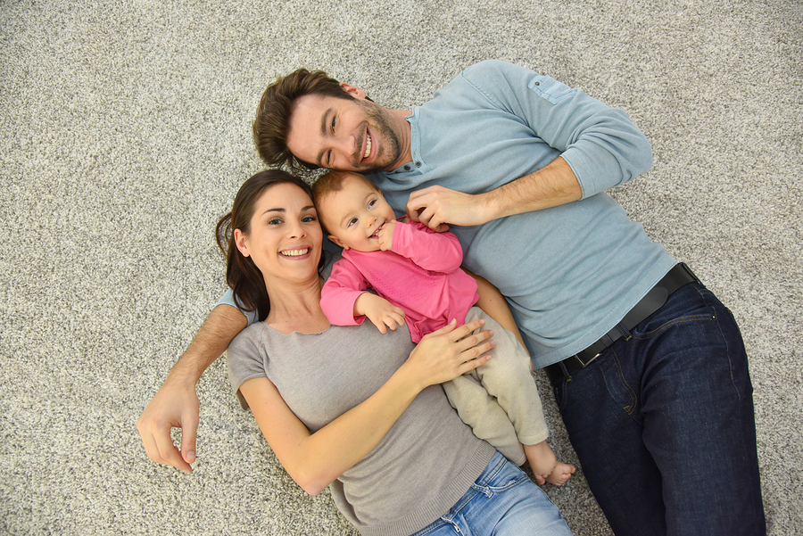 family laying on carpet